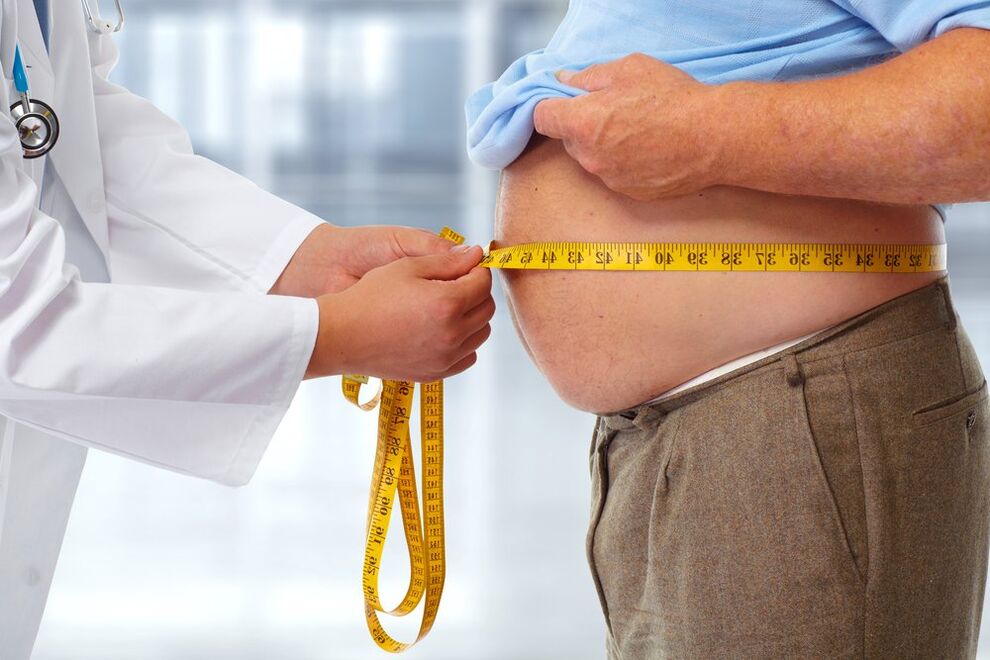 The doctor measures the patient's waist during a diet